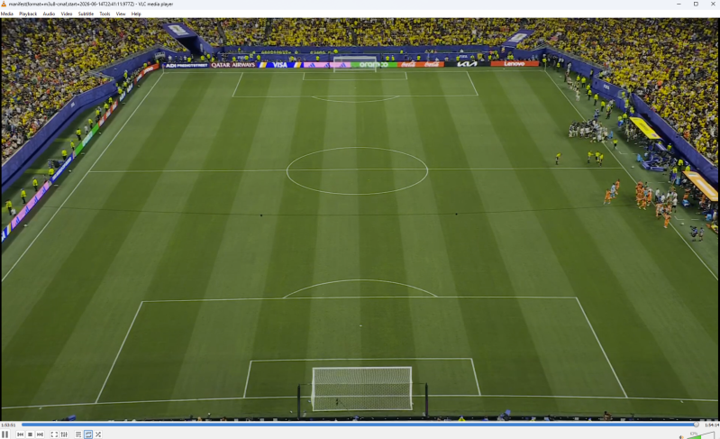 A VLC media window with a live feed of a soccer field. Players are just starting to come off the sideline to play.