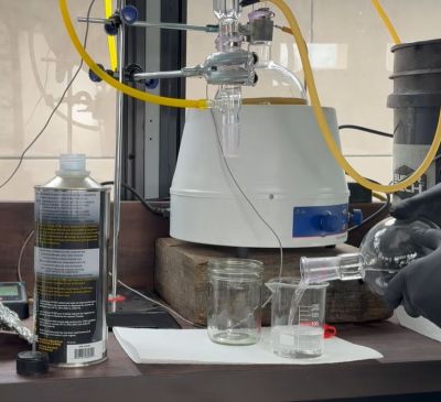 Pouring the resulting distillate for testing. (Credit: Lowered Expectations, YouTube)