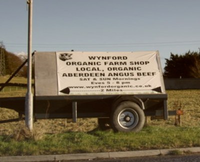 A sign advertising Wynford Farm Shop, selling local Organic Aberdeen Angus beef.