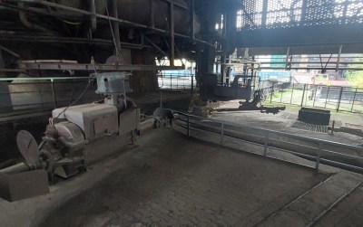 The base of the furnace is on the left, and a stone floor with channels in it for molten iron is in front of the camera.