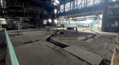The base of the furnace is on the left, and a stone floor with channels in it for molten iron is on the right.