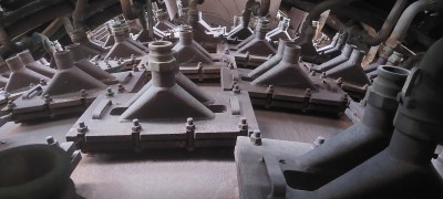 We're looking upwards up the side of the furnace, and in front of us are s series of conical ifittings coming out to pipes.