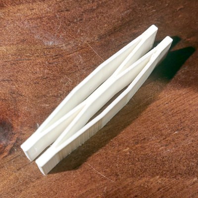 A 3d printed spring in white plastic