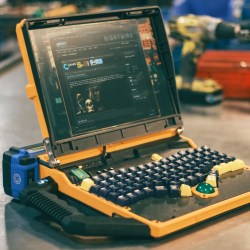 Custom laptop, open to show eronomic keyboard and trackball.