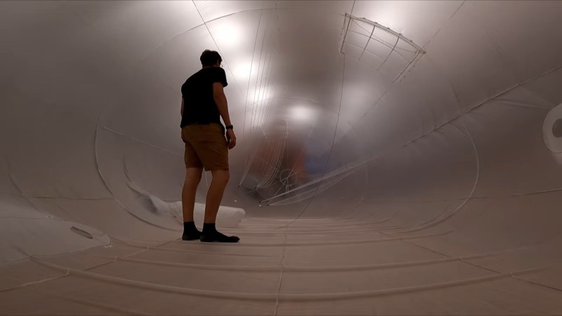 [Avery] standing inside the inflating envelope of his airship